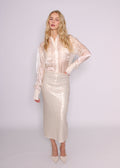BRISTOWE Corine ivory sequin maxi skirt on a model wearing a sheer ivory shirt and pointed heels.