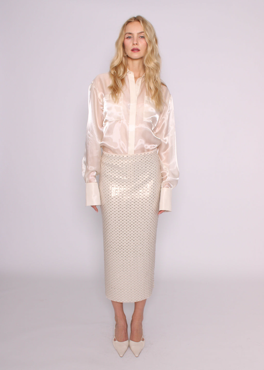 Front view of the BRISTOWE Corine ivory sequin maxi skirt showing its straight silhouette, styled with an ivory shirt.