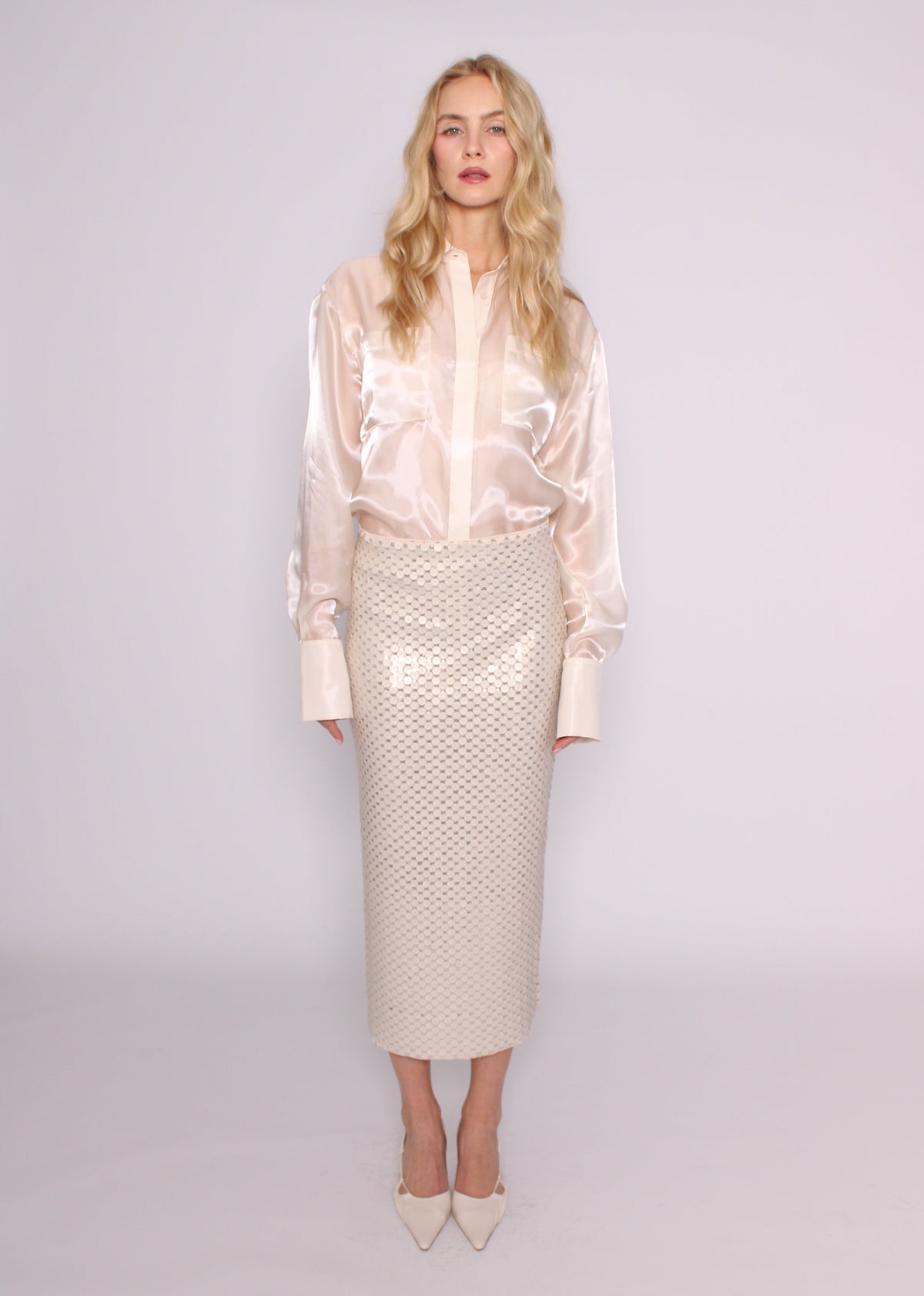 Front view of the BRISTOWE Corine ivory sequin maxi skirt showing its straight silhouette, styled with an ivory shirt.